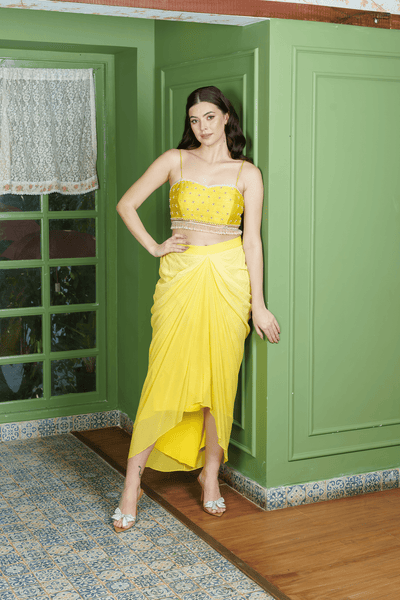 Woman wearing citrus drape dhoti set with crop top in citrus yellow