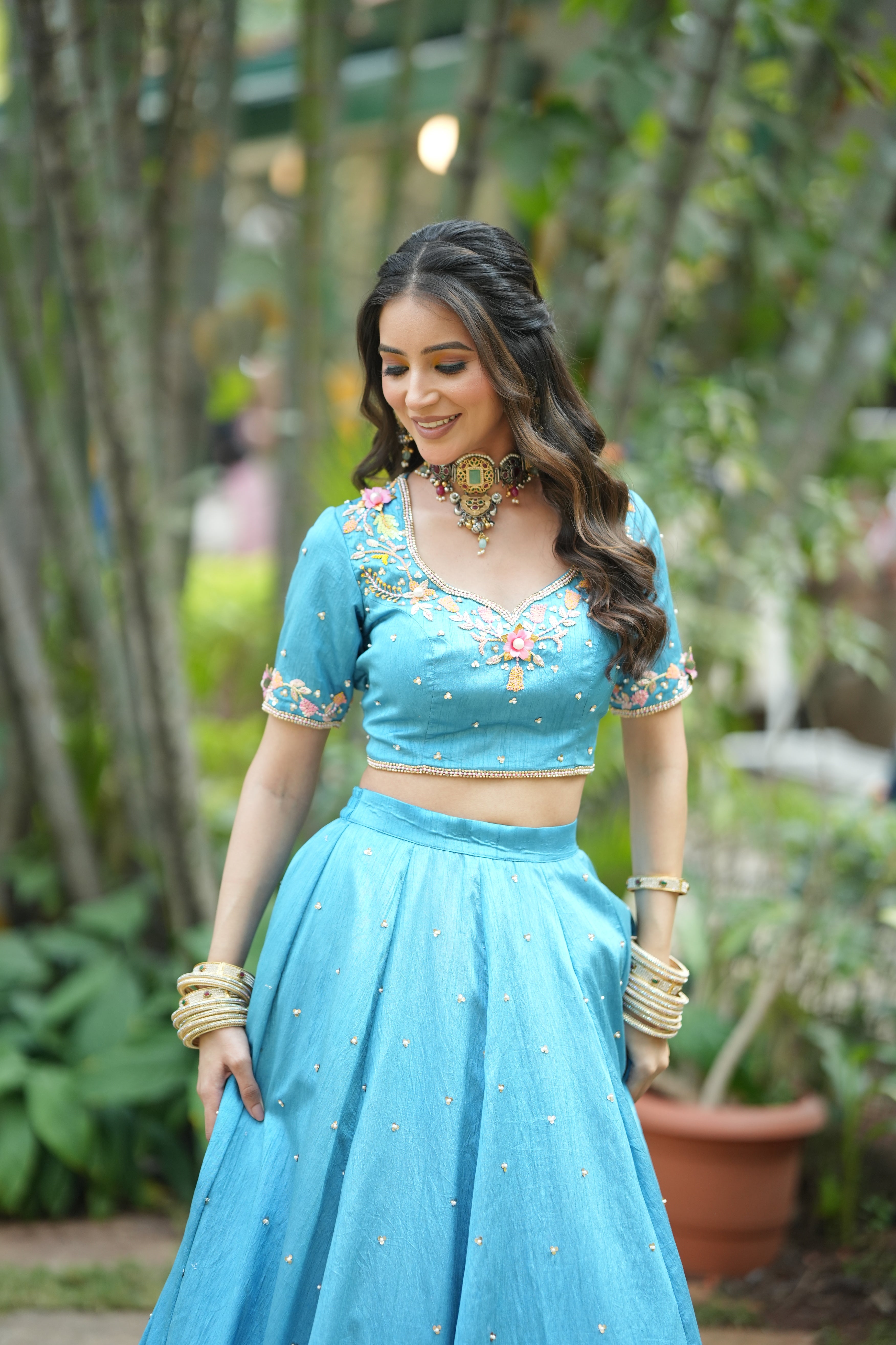 Stylish aviary bloom sky blue raw silk lehenga with peacock embroidery at the hem