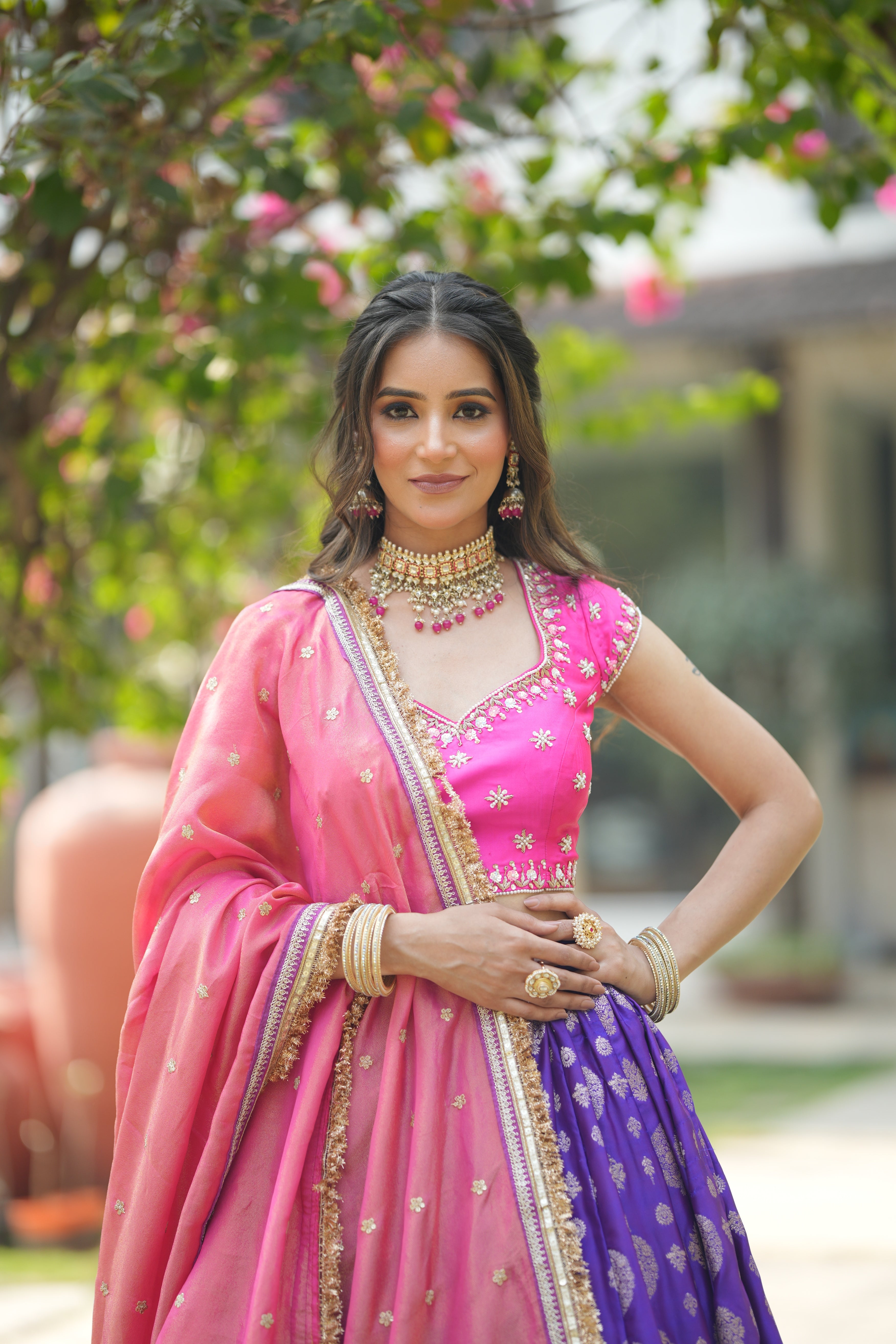 Close-up of mirror work embroidery on hot pink blouse of Banarasi lehenga set