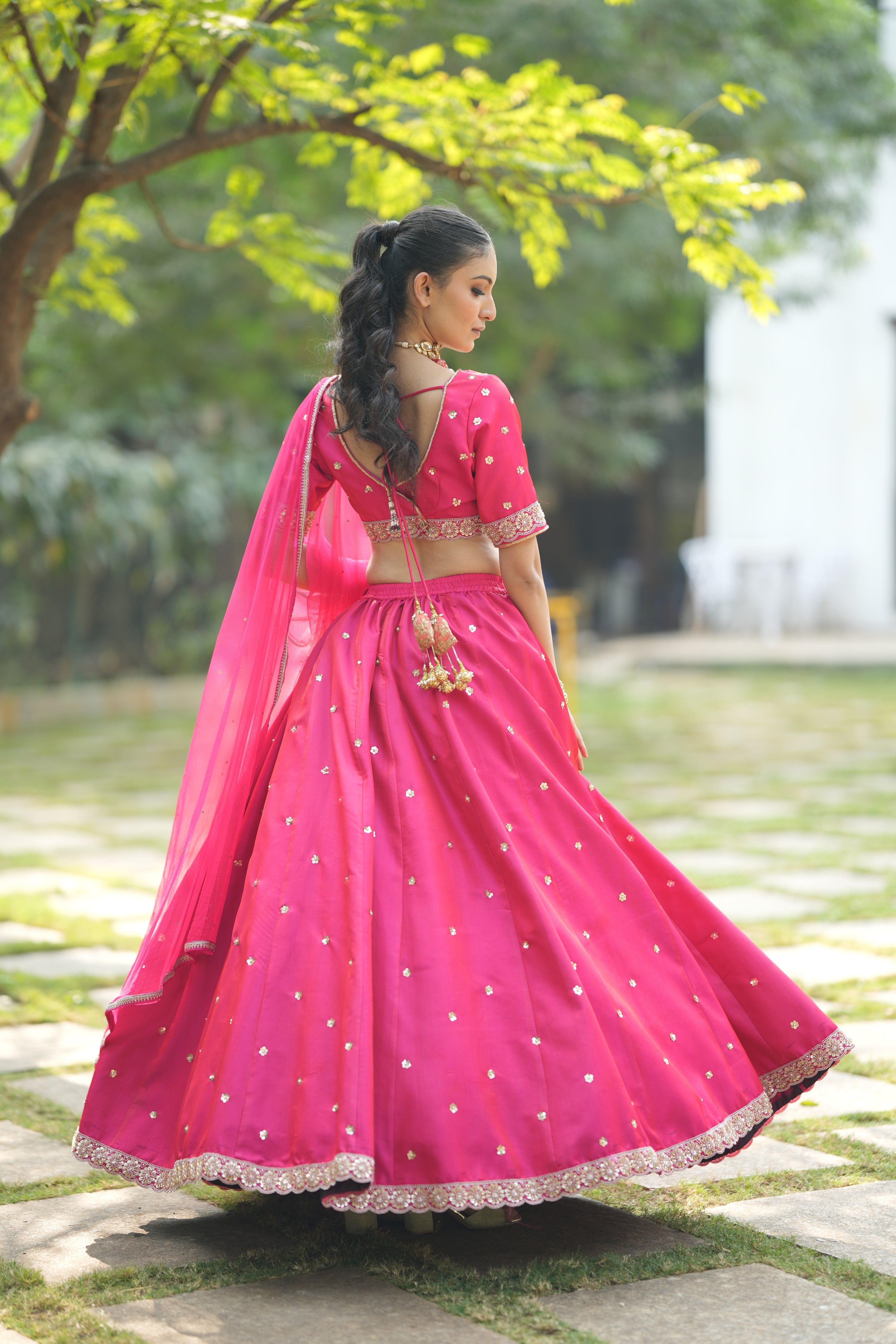Back view of the Designer Red Silk Bridal Lehenga, showcasing its beautiful cut and luxurious silk material.
