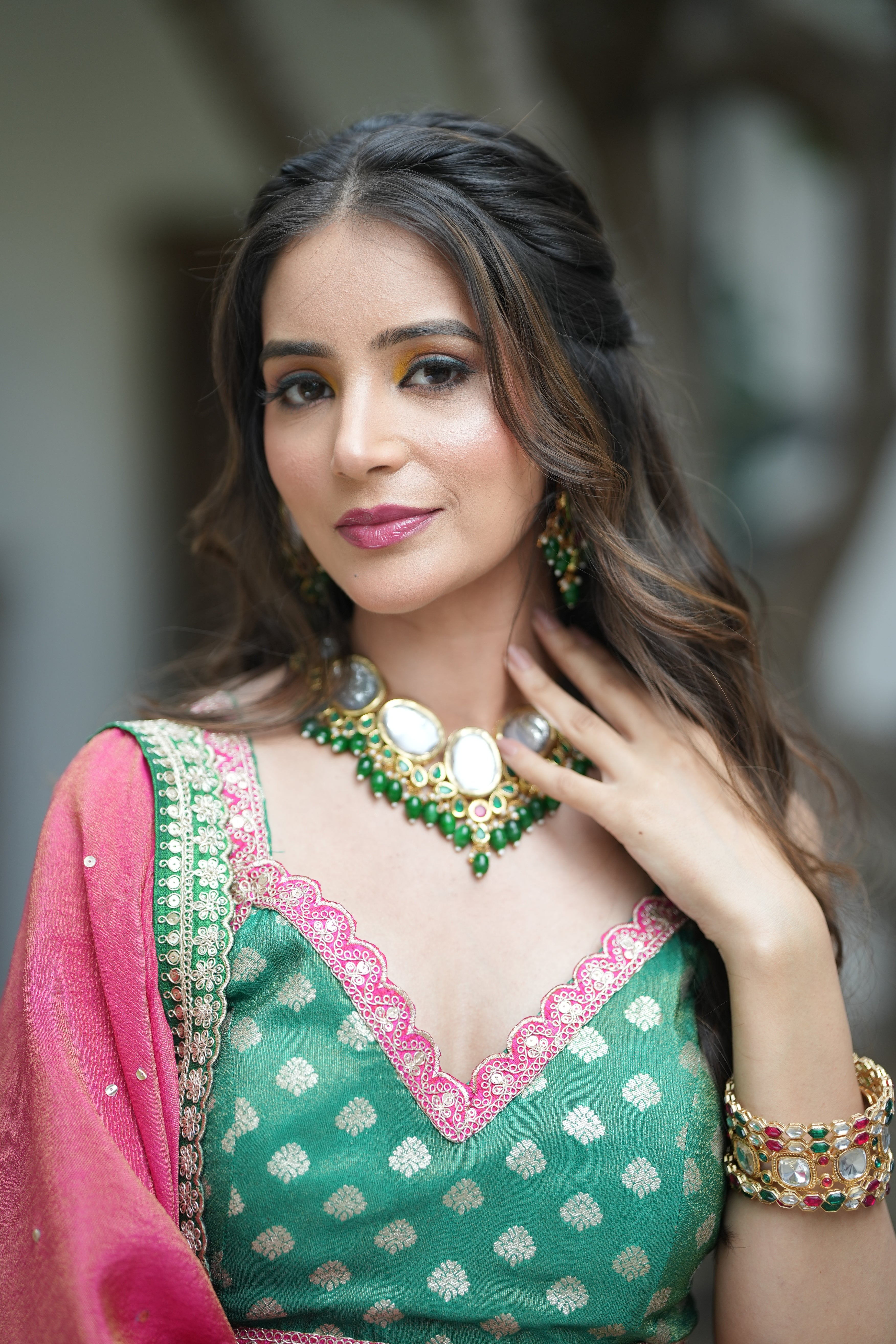 Stunning shot of the Emerald Opulence Green Banarasi Lehenga with dupatta and gold jewelry set.