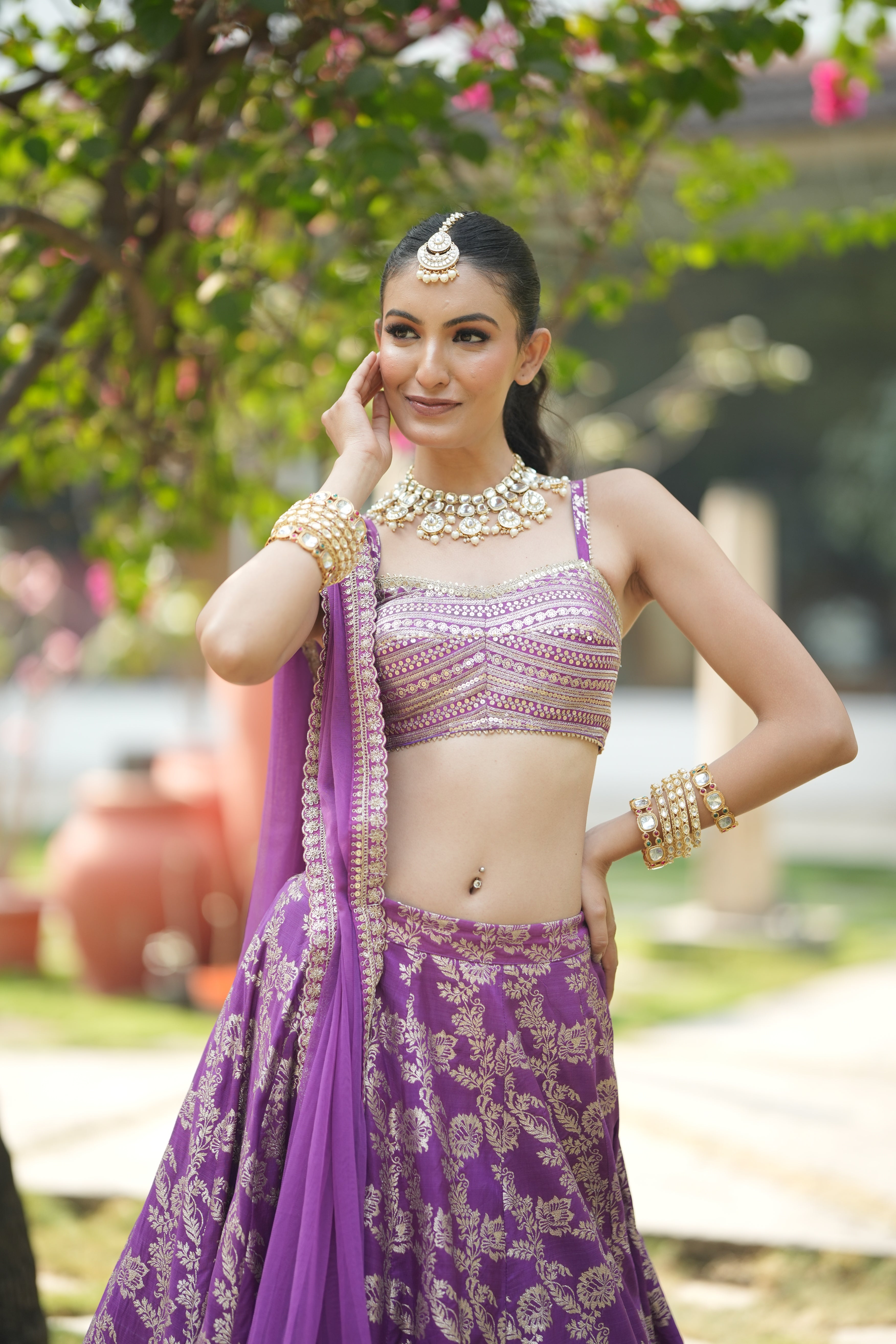 Lavender festive lehenga set with soft net dupatta and golden border detailing.