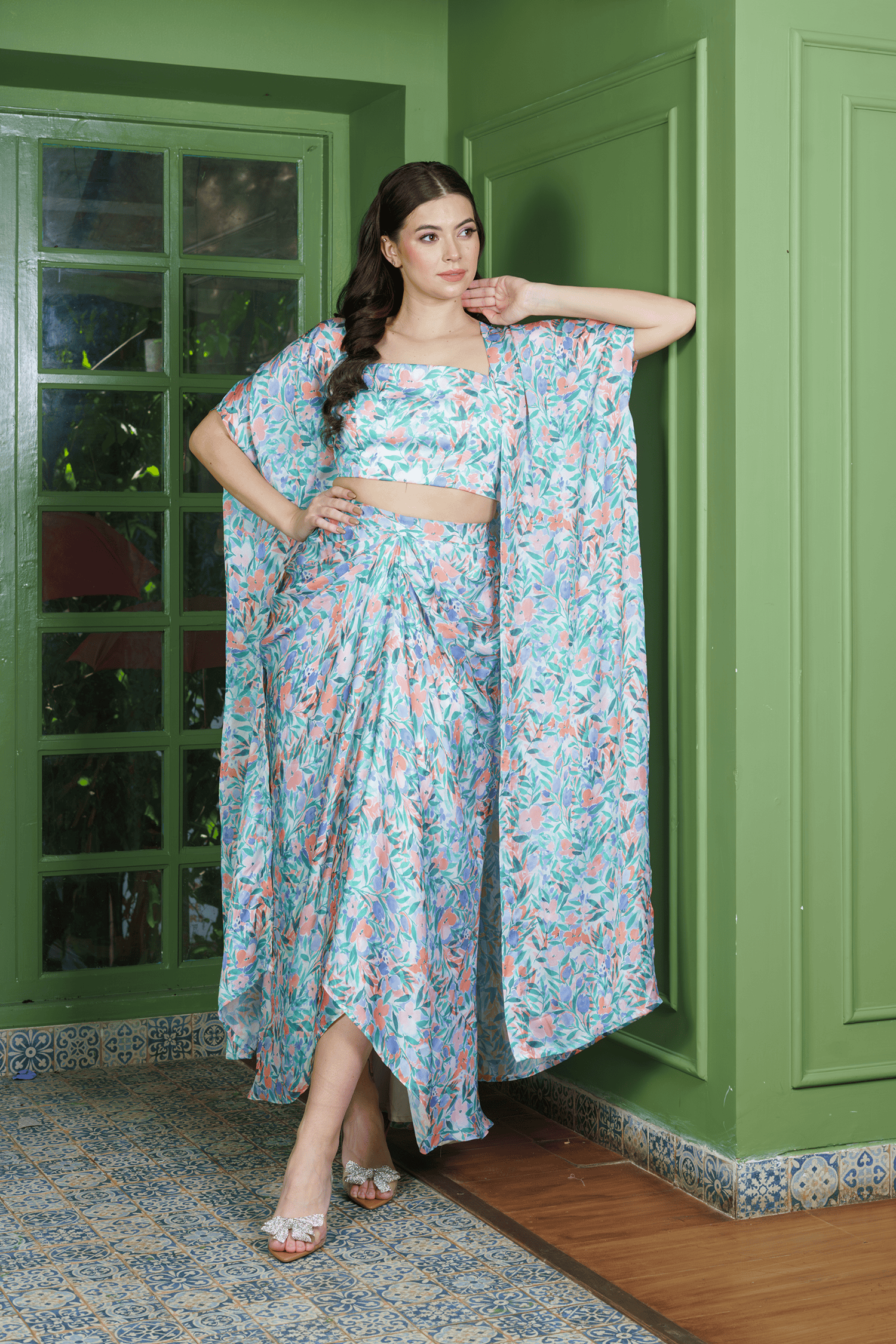 Model wearing leafy print dhoti set for women with crop top and long jacket – perfect indo western outfit for festive and wedding occasions.