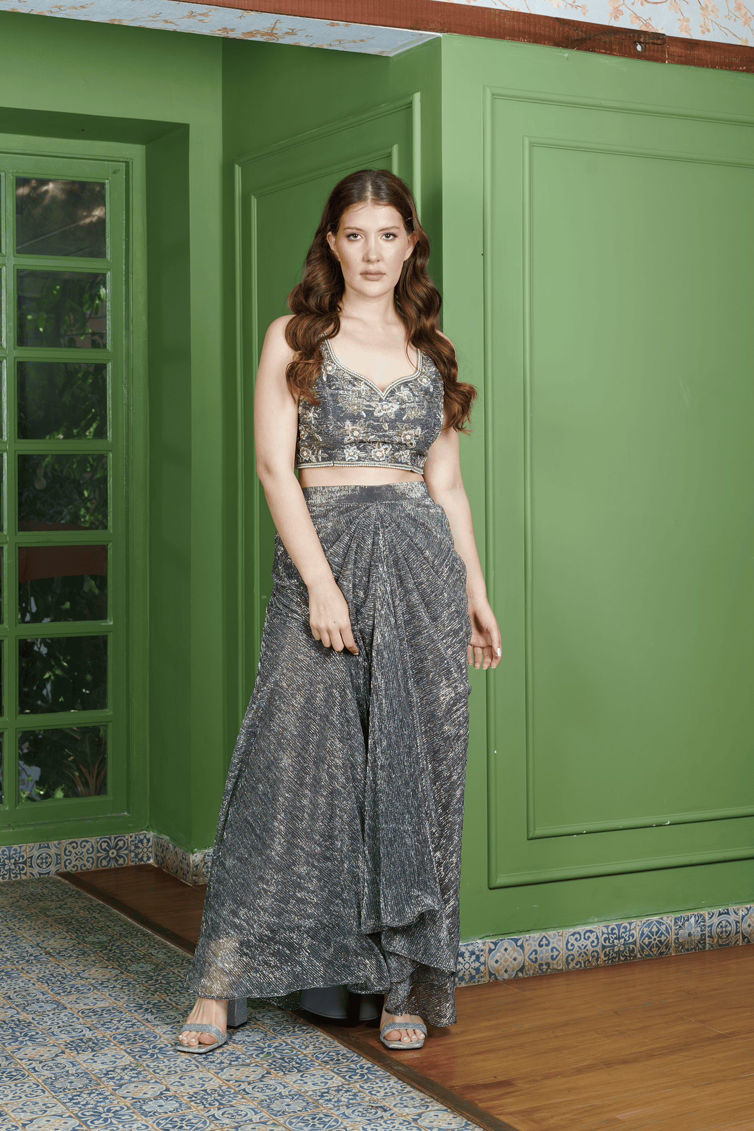 Front view of gray dhoti set for women featuring shimmer dhoti skirt and floral embroidered crop top ?festive Indo-Western outfit by Neha Sharma Label.