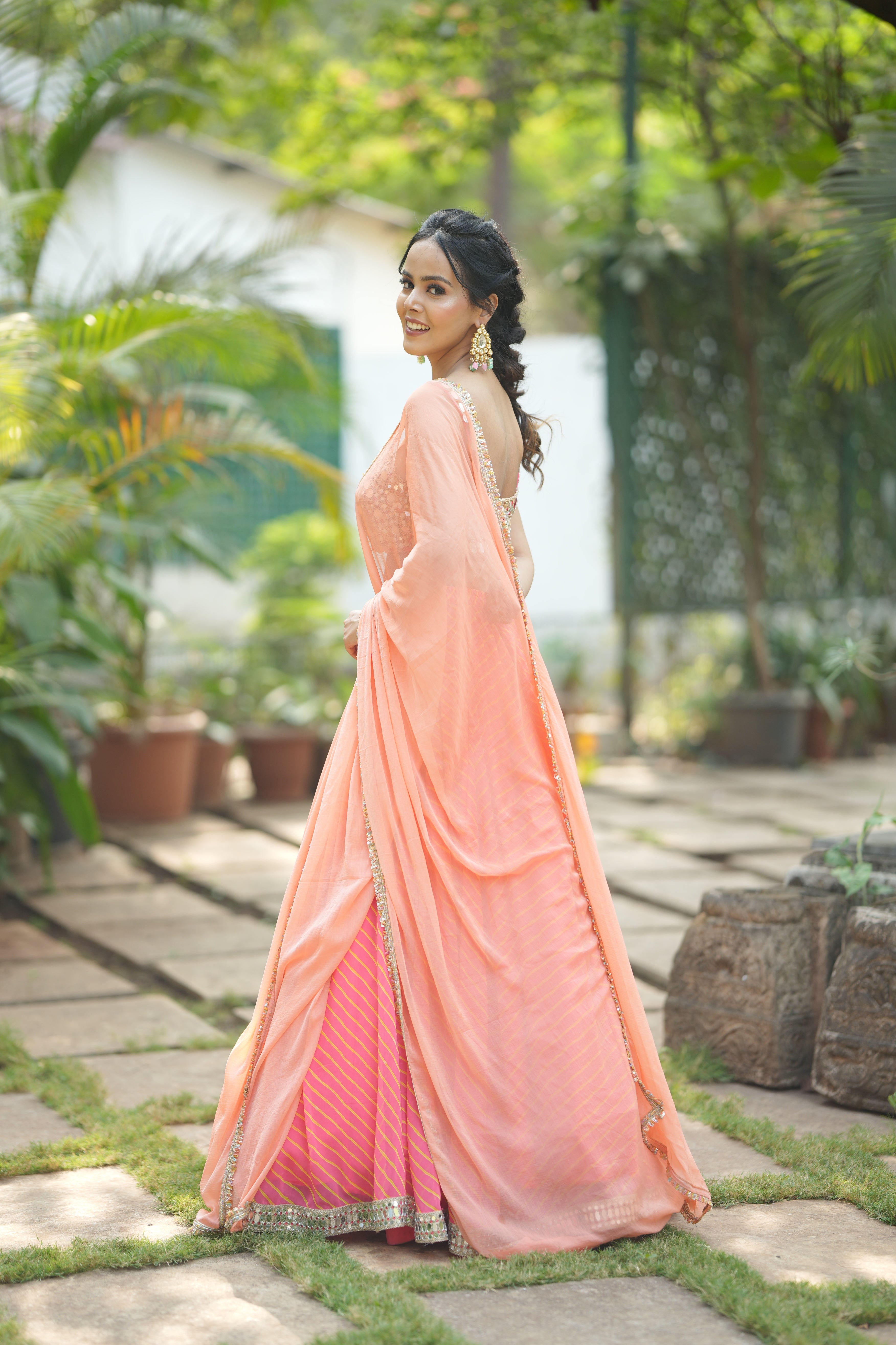 Mirror embellished sleeveless blouse paired with Sunset Stripes designer lehenga