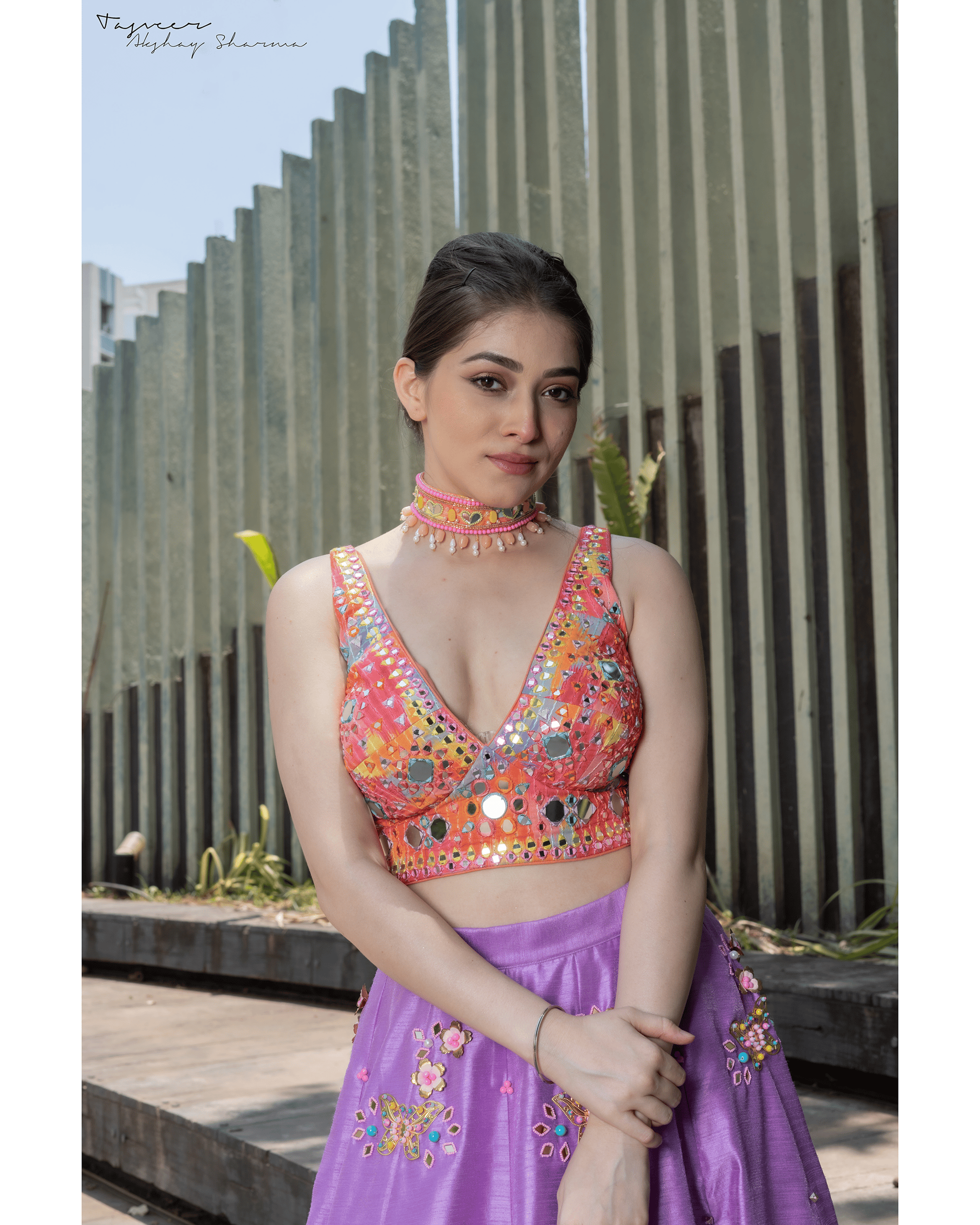 Close-up of mirror work and hand embroidery on lilac lehenga crop top.