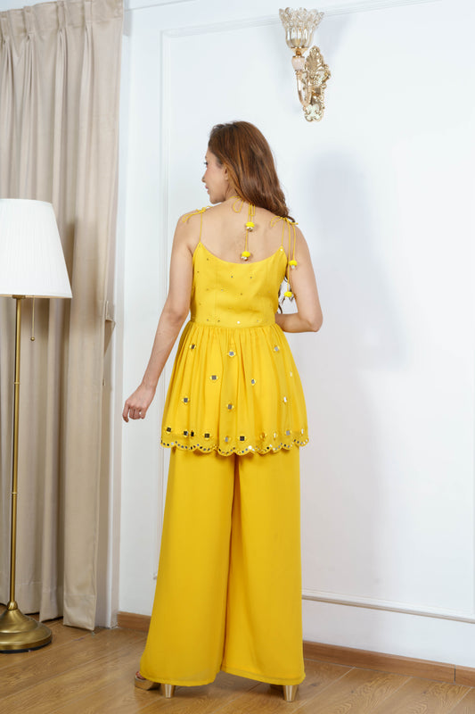 Sleeveless mustard kurta set for women with tie-up detail ?back view.