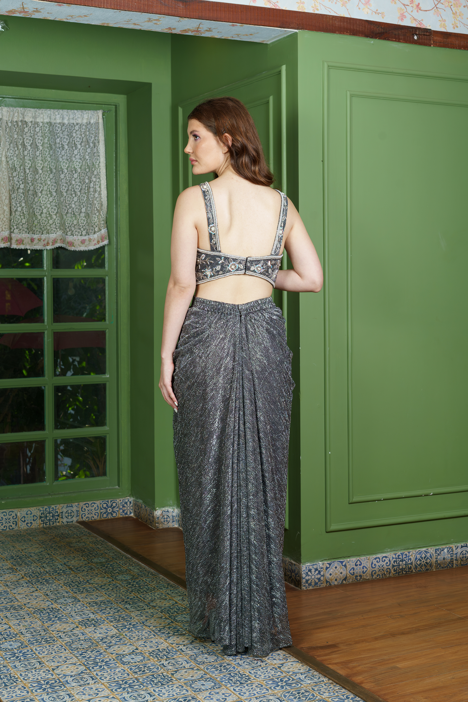 Back view of stylish dhoti set for women featuring open-back embroidered blouse and metallic draped dhoti – perfect for festive and party wear.