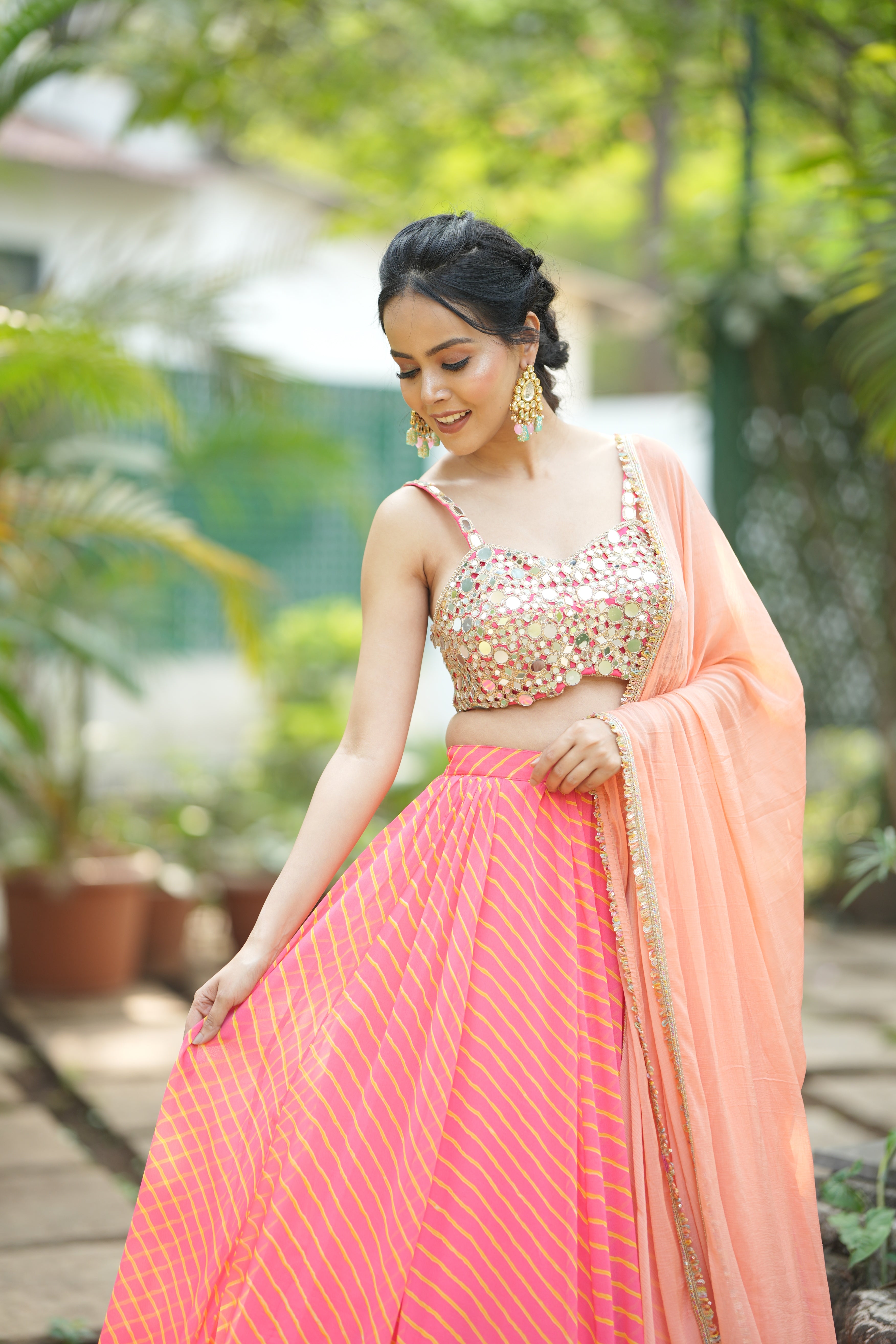 Mirror embellished sleeveless blouse paired with Sunset Stripes designer lehenga