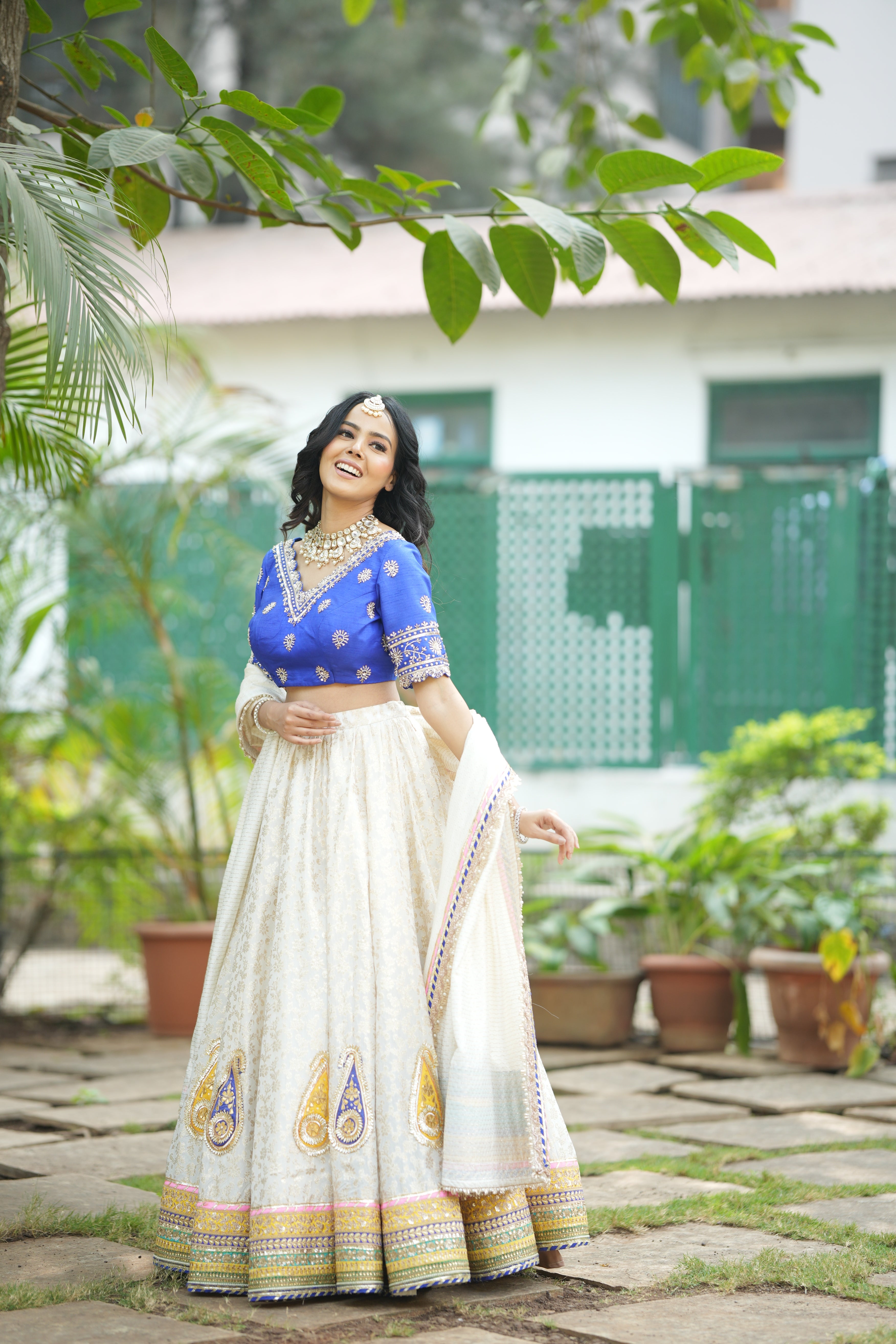 Banarasi lehenga skirt with golden motifs and multicolor border details.