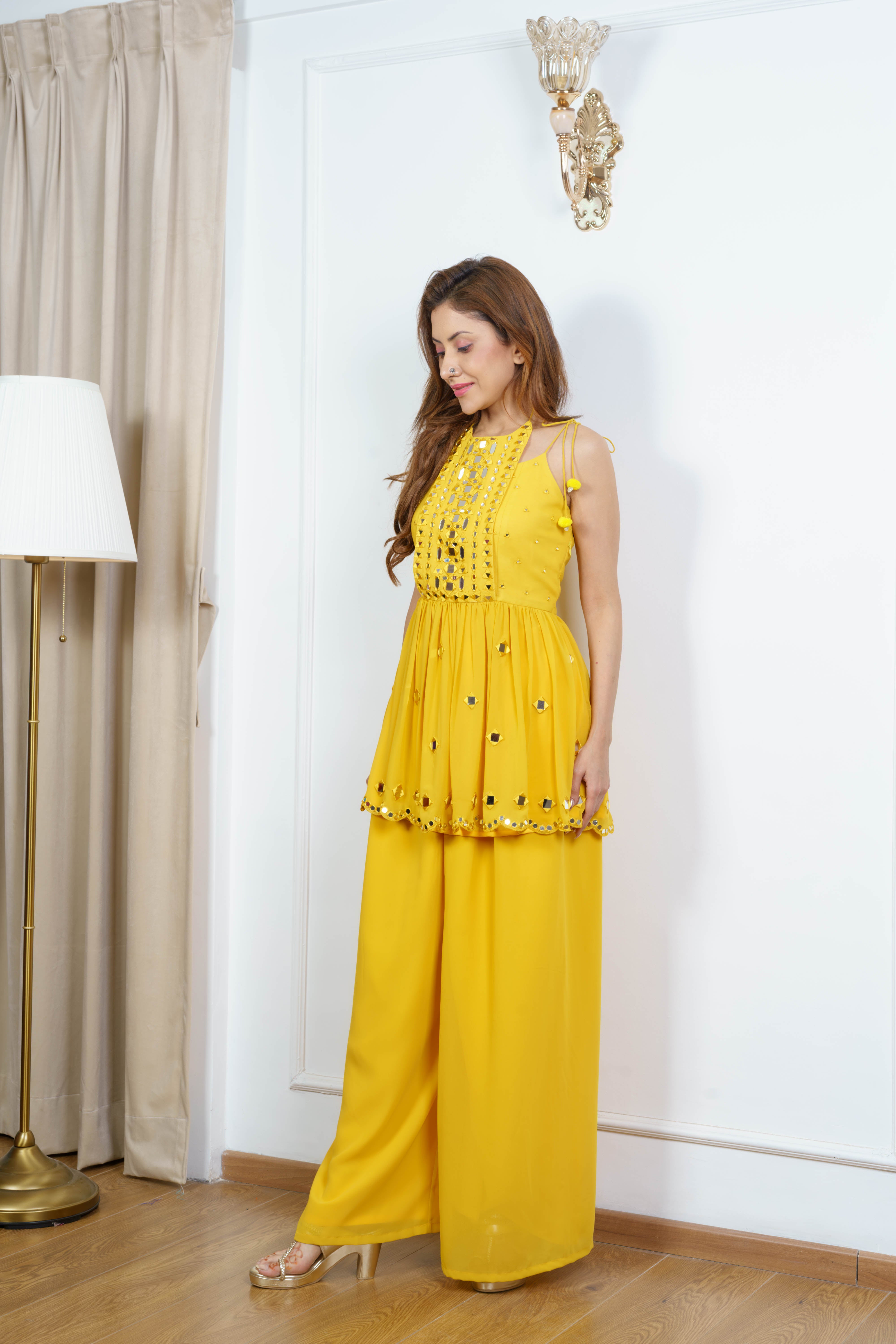 Sleeveless designer kurta set for women styled for Navratri & festive look with traditional mirror work detailing