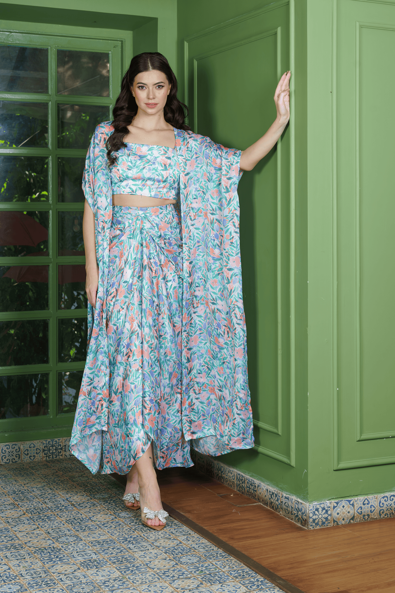 Trendy leafy print dhoti set – stylish indo western fusion wear for weddings or festive events, featuring a crop top, draped dhoti skirt, and long jacket.