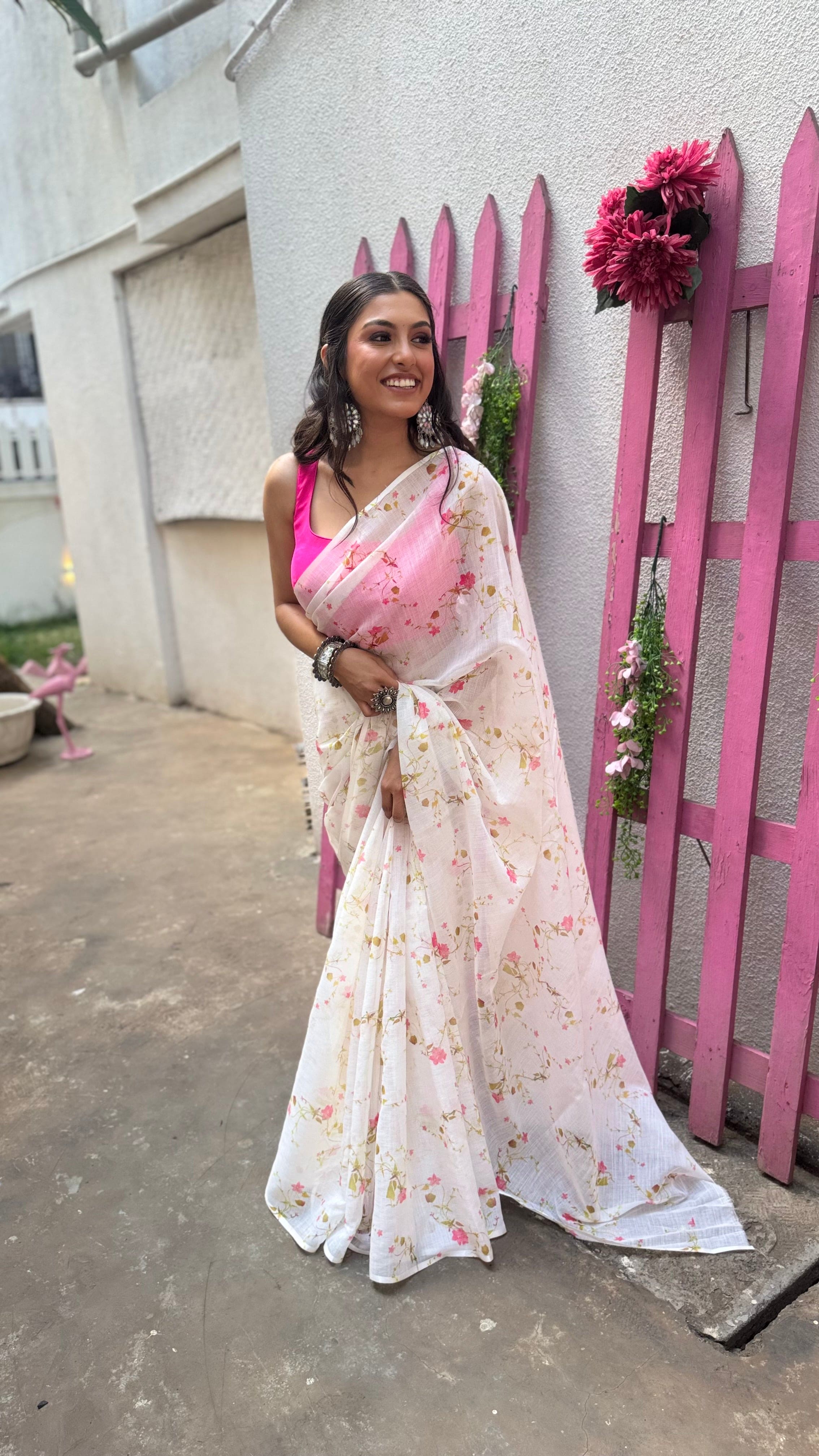 Model wearing white cotton saree with pink and yellow floral print