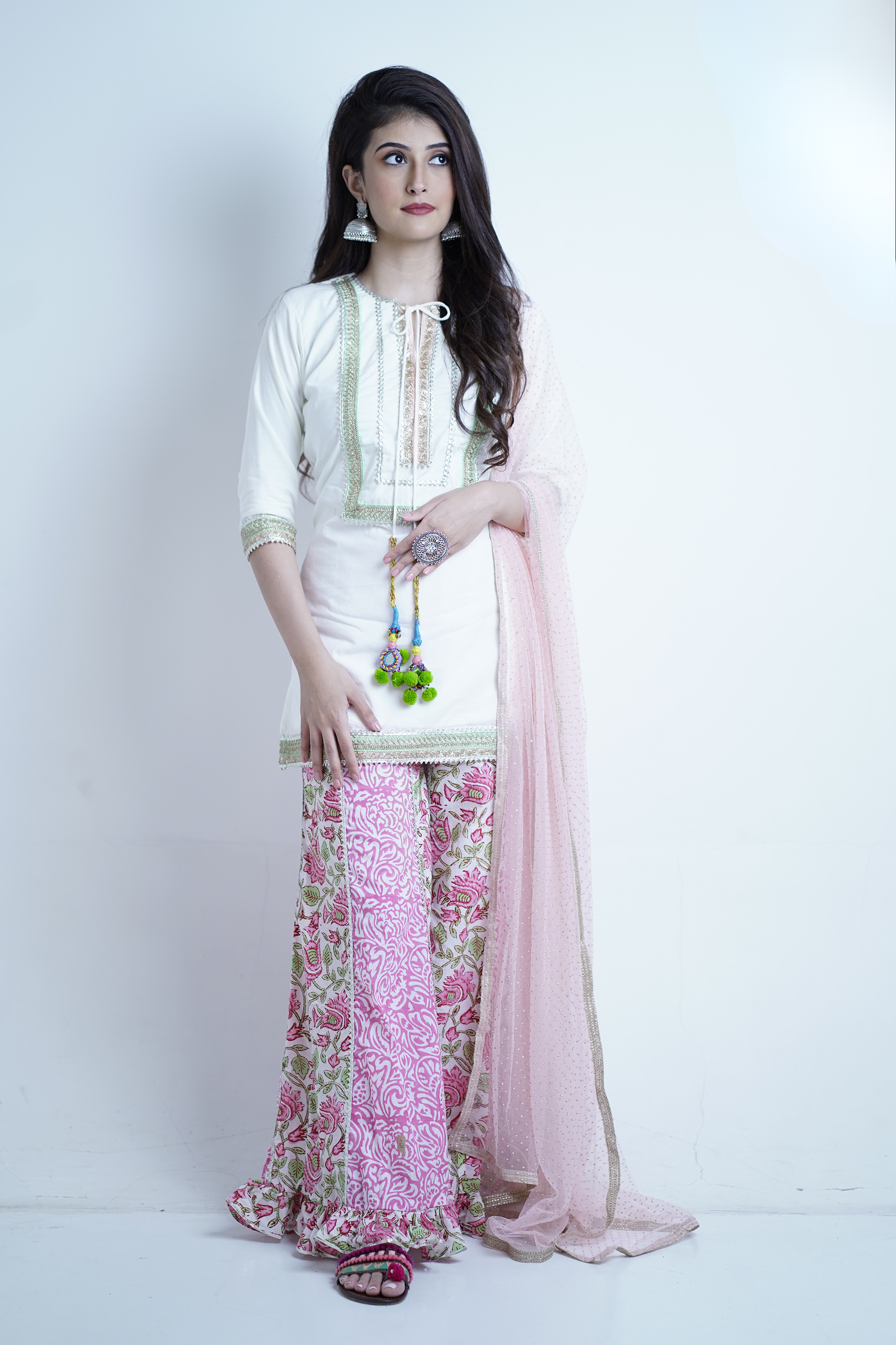 White kurta palazzo set styled for festive or elegant occasions