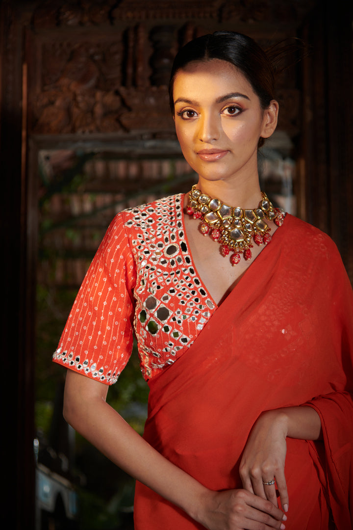 Dark orange printed blouse with ruffle saree