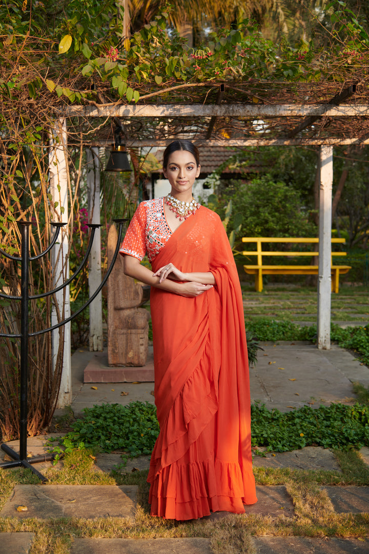 Dark orange printed blouse with ruffle saree