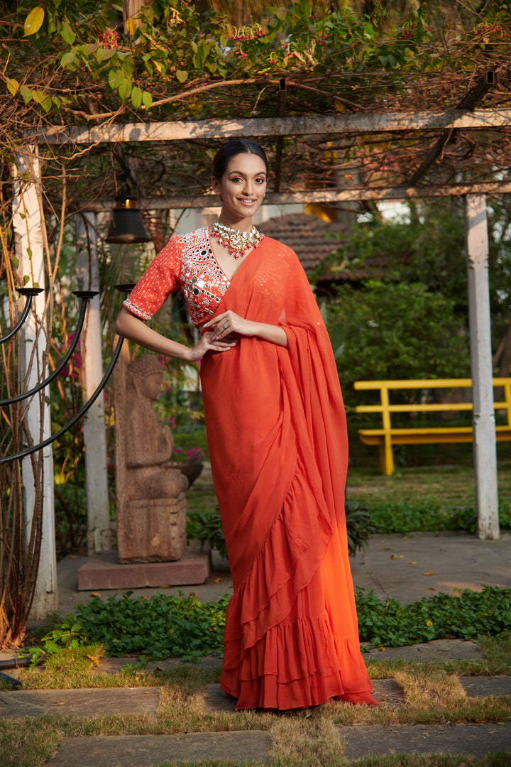 Dark orange printed blouse with ruffle saree