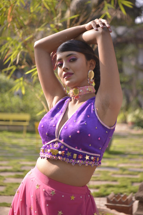 Rani pink net lehenga with purple velvet blouse