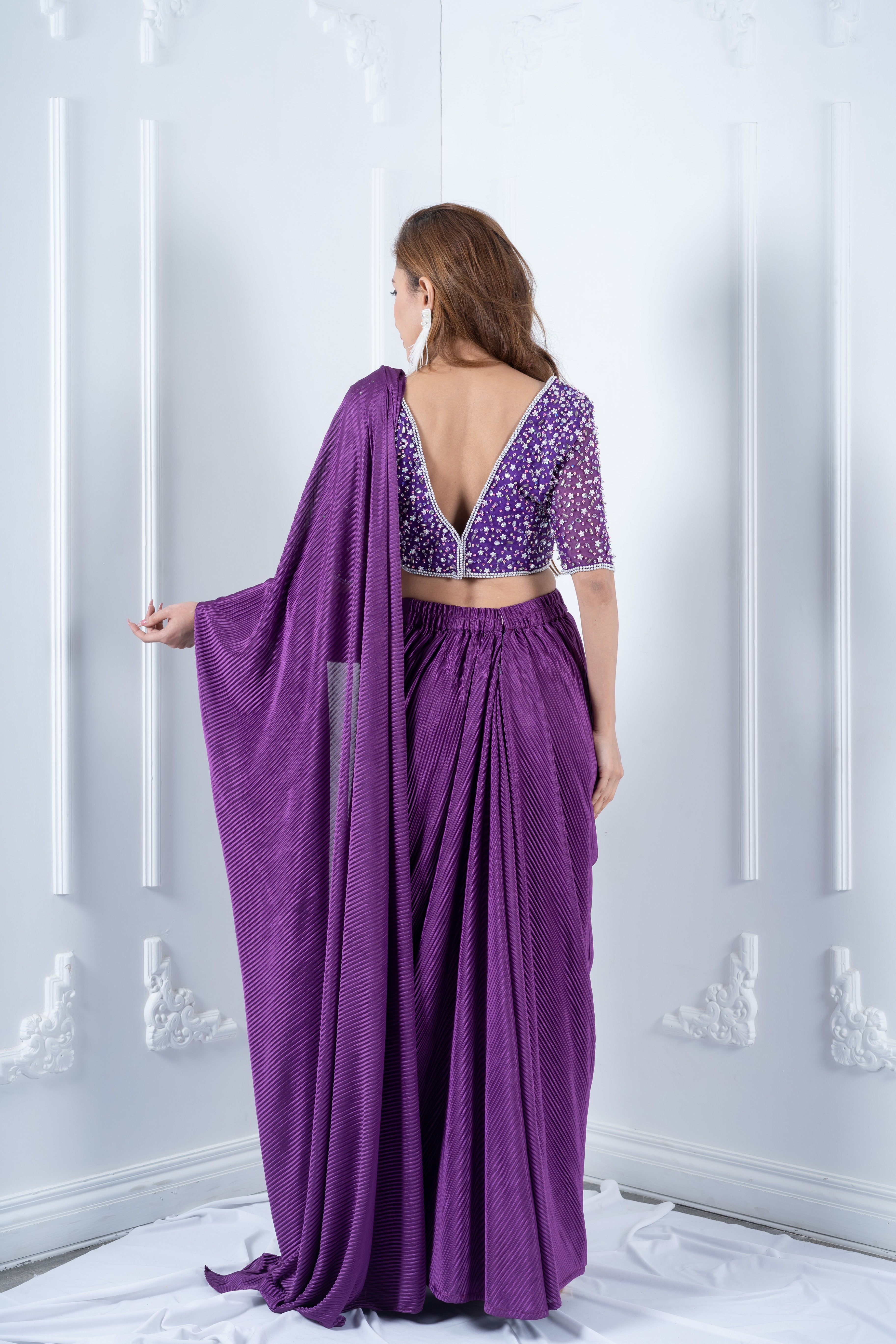 Purple hand embroidered blouse with pleated drape saree