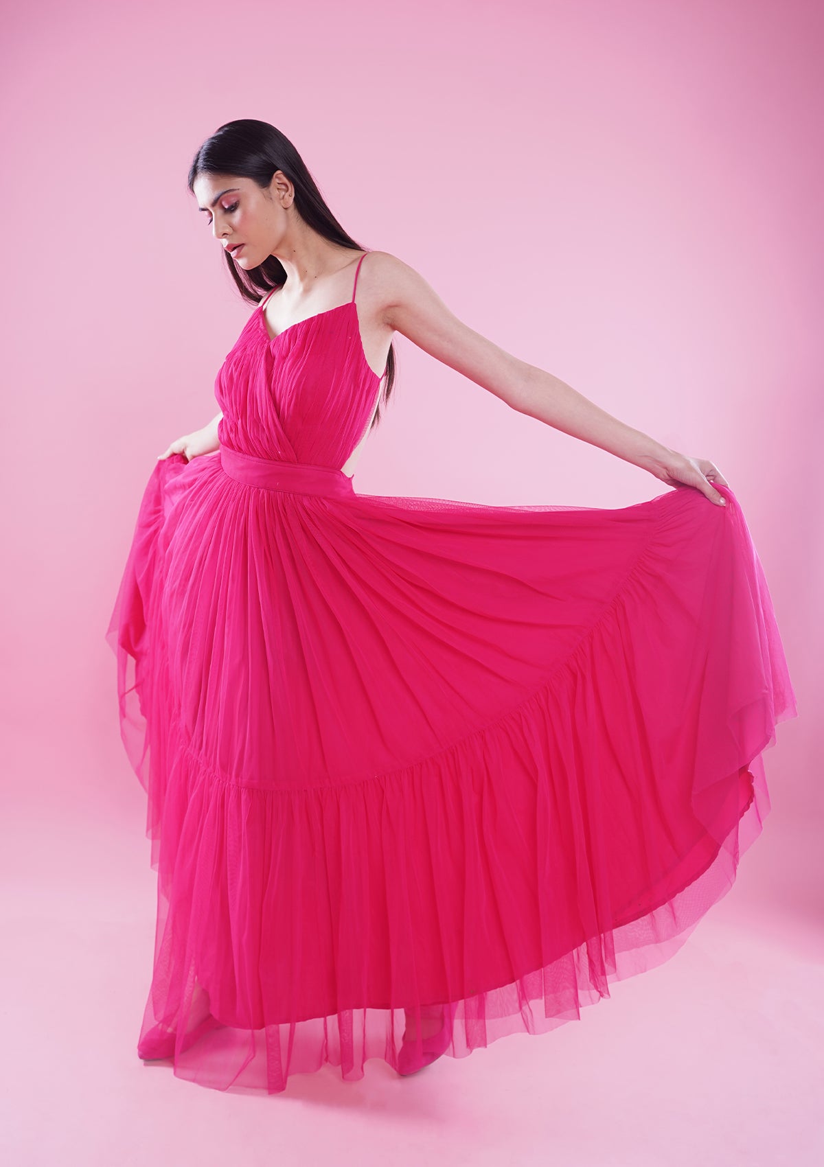 Fuschia pink long ruffled gown and strappy sleeves with backless pattern