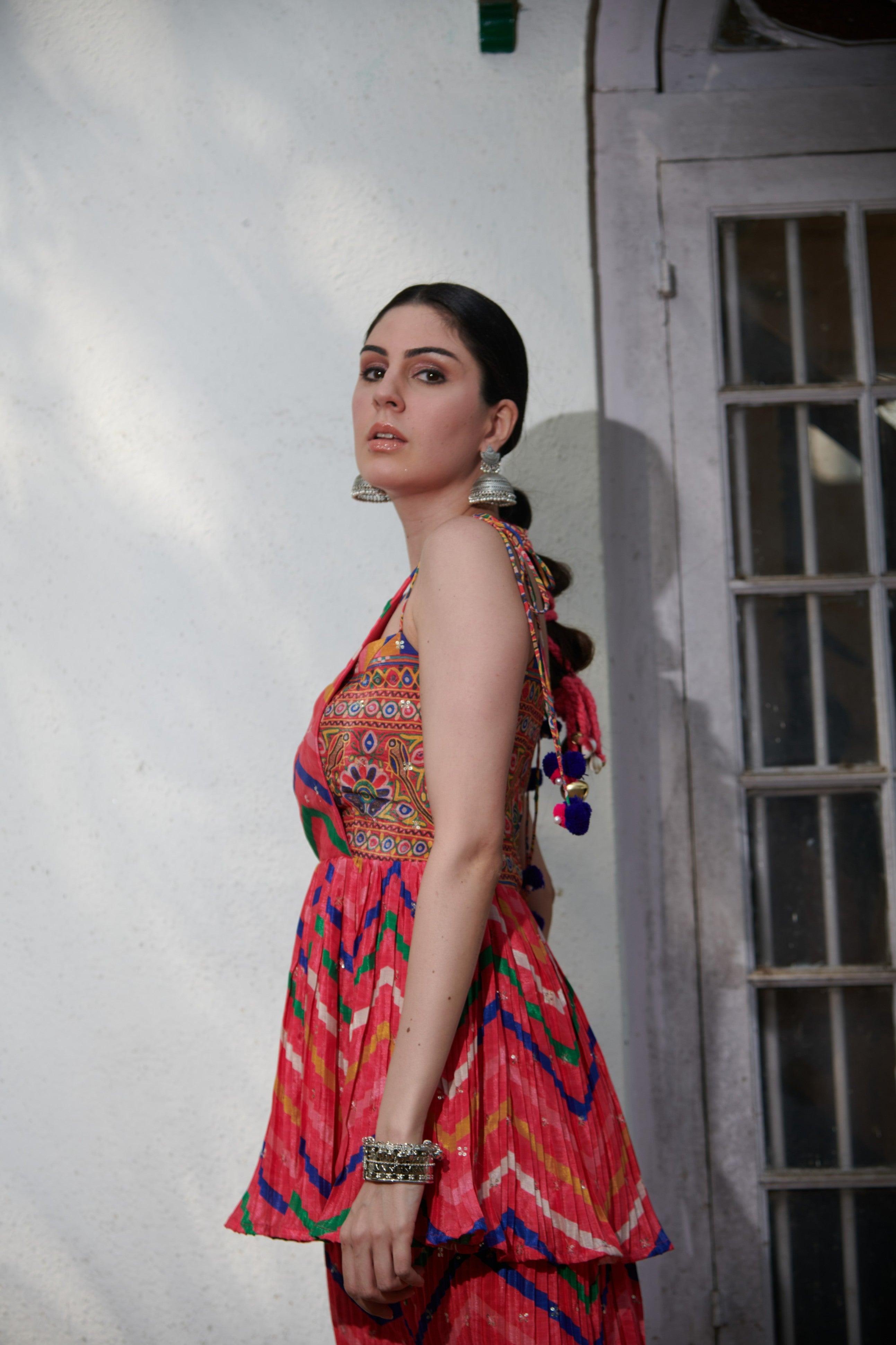 Side profile of stylish kurta set for women with peplum silhouette and wide-leg embroidered pants.