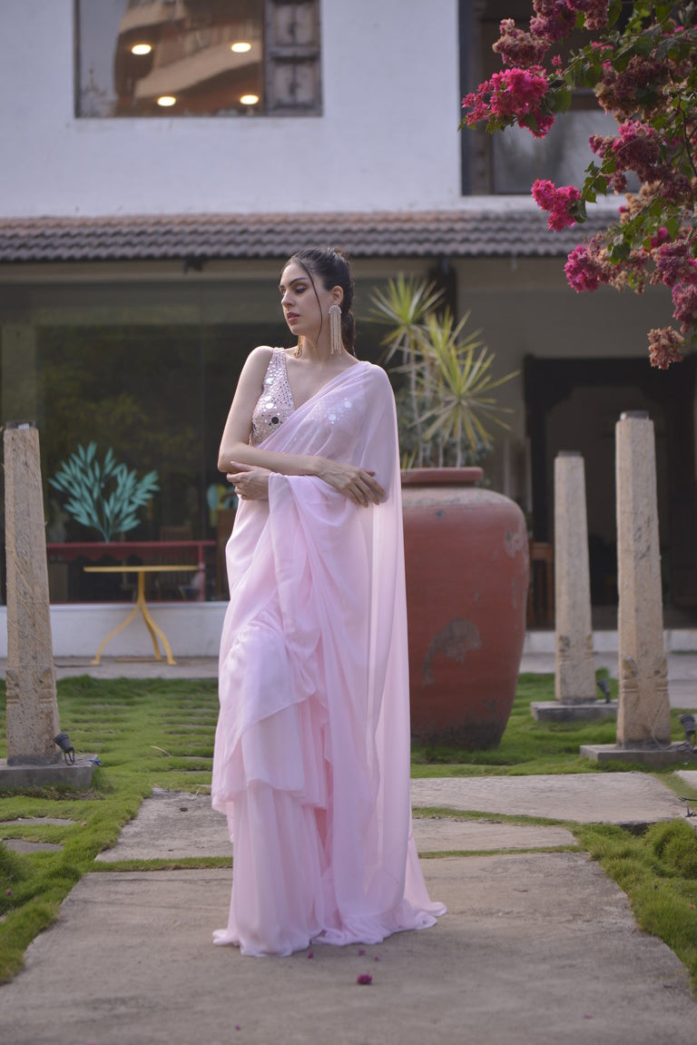 Pastel pink ruffle saree with mirror work blouse
