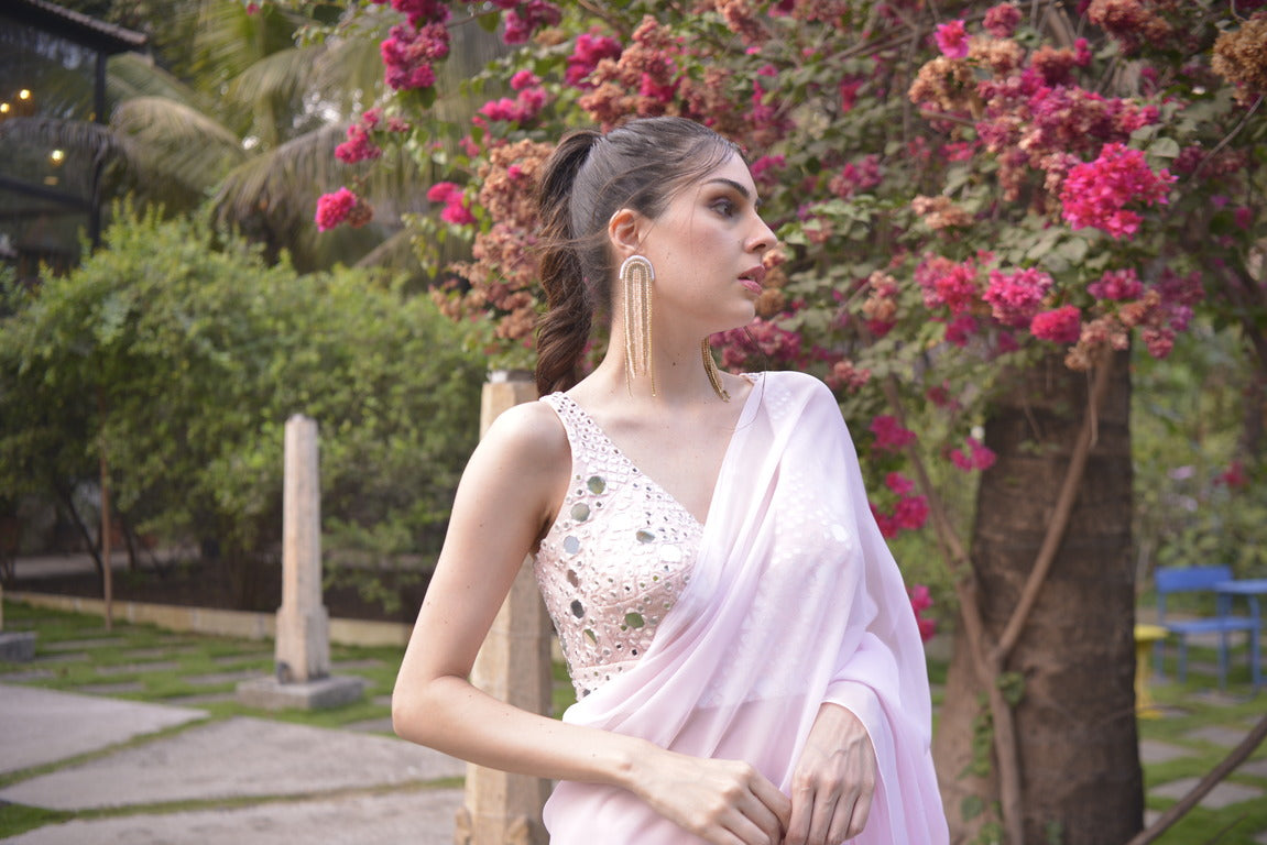 Pastel pink ruffle saree with mirror work blouse