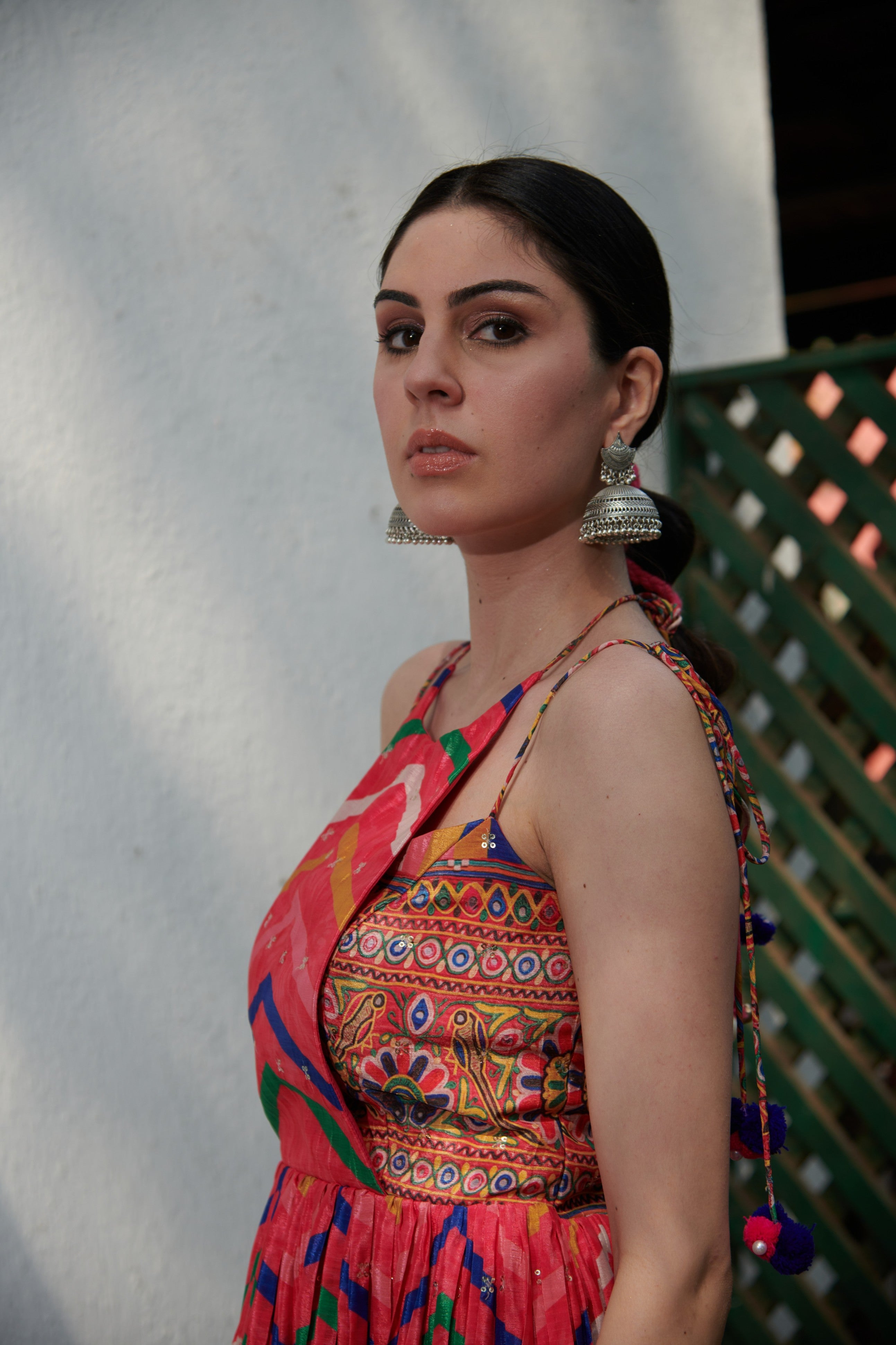 Closeup of neckline and mirror detailing on sleeveless kurta set, ideal for party wear and weddings.