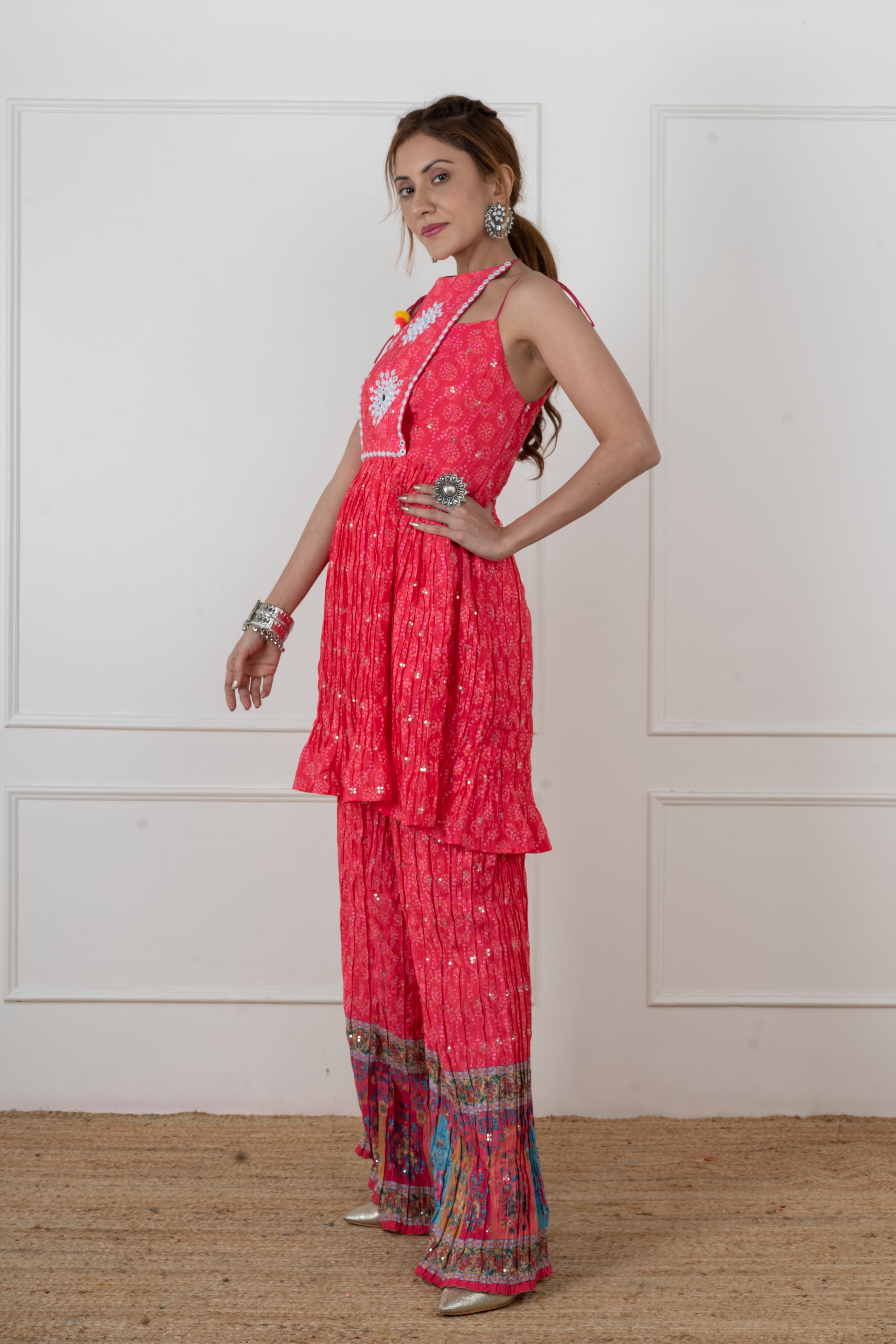 Pink Bandhani kurta palazzo set styled with silver bangles and jhumka earrings