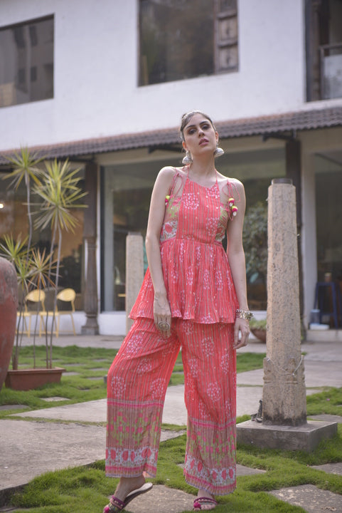 Model wearing orange sleeveless kurta palazzo set for festive and resort wear